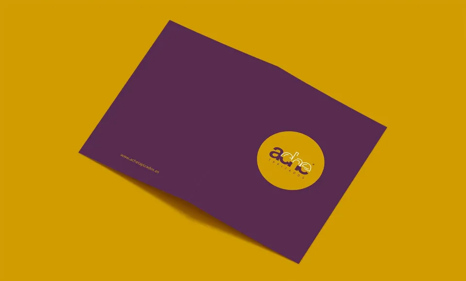 Purple Ache corporate folder with the logo in a mustard circle, on a mustard background