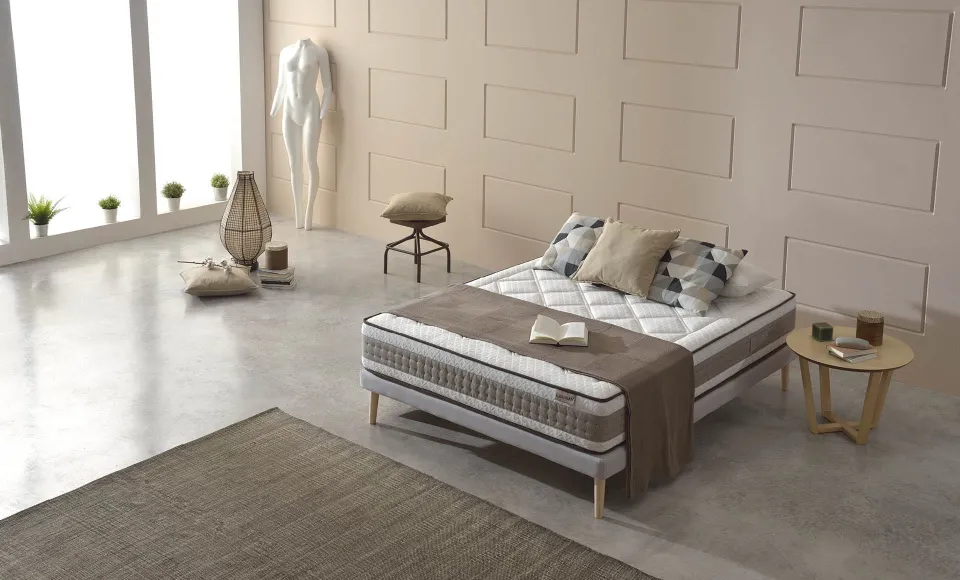 Cama con colchón de Karibian Descanso en un dormitorio cálido con maniquí de vestir