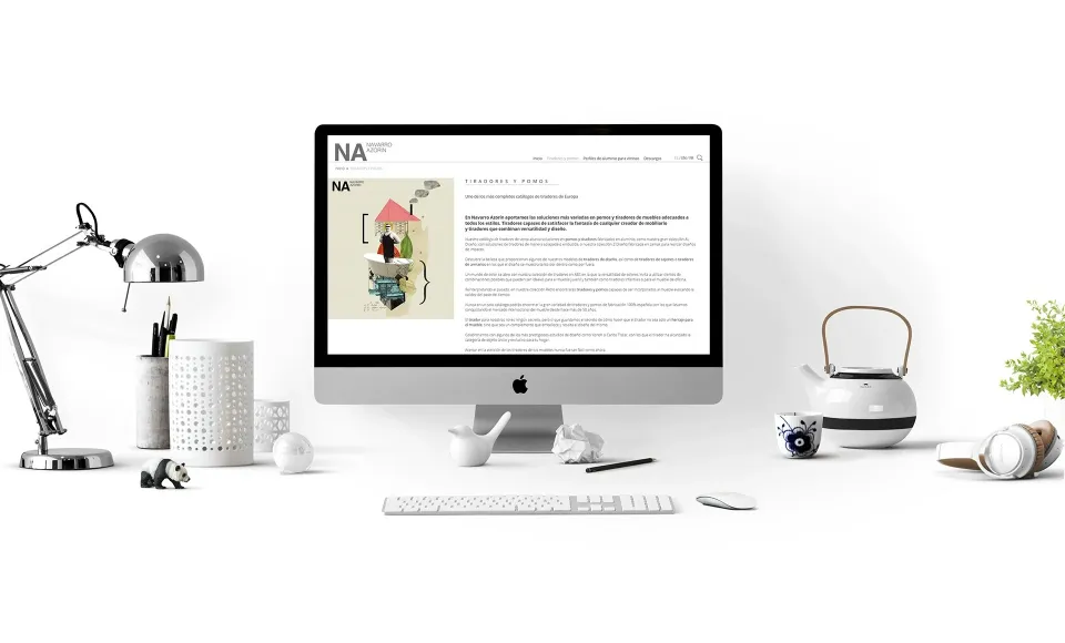Navarro Azorín website open on an iMac on a desk with a lamp and a teapot
