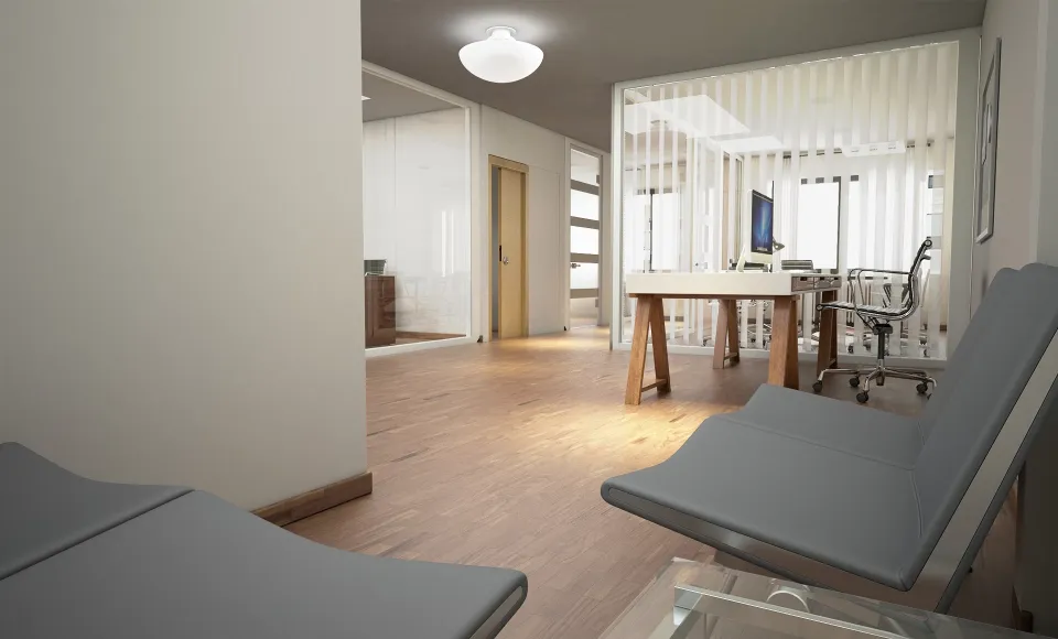 3D render of a corridor with grey loungers and a glazed office beyond