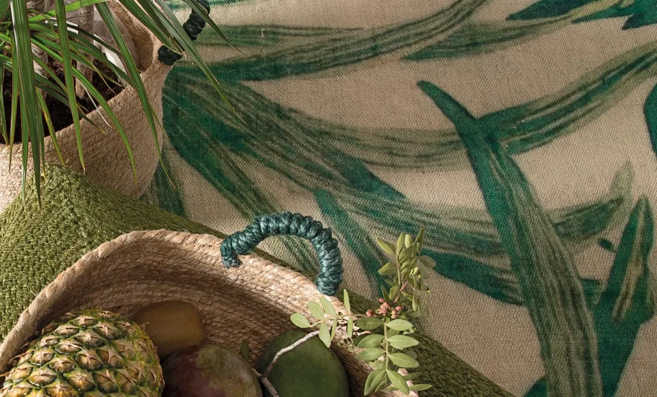 Tropical-print fabric and a woven basket with a pineapple by Parentesi Quadra