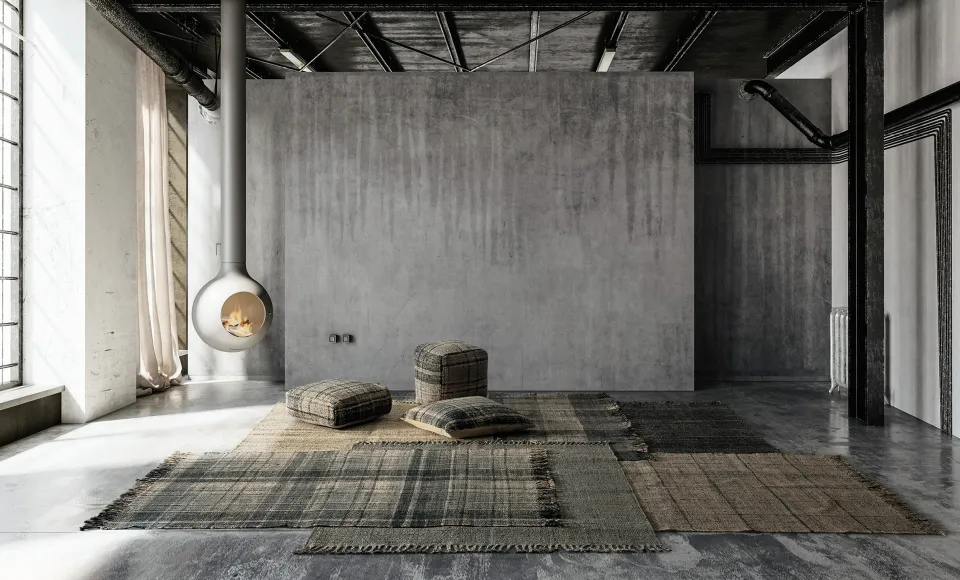 Parentesi Quadra patchwork rugs on the floor of a loft with concrete walls