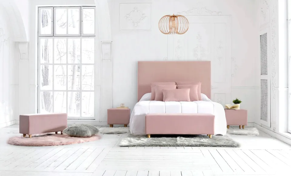 Pink-toned bedroom with an upholstered bed and a gold pendant light by Parentesi Quadra