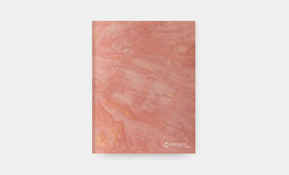 Portada del catálogo de Tapicerías Navarro en mármol rosa con el logotipo de la marca