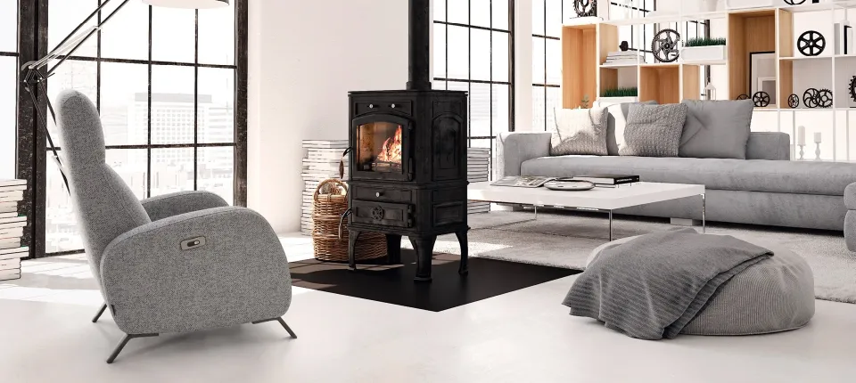 Loft-style living room with a grey recliner, a wood-burning stove and a pouf by the sofa