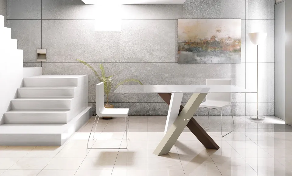 Comedor con mesa de patas cruzadas en madera y blanco, junto a una escalera